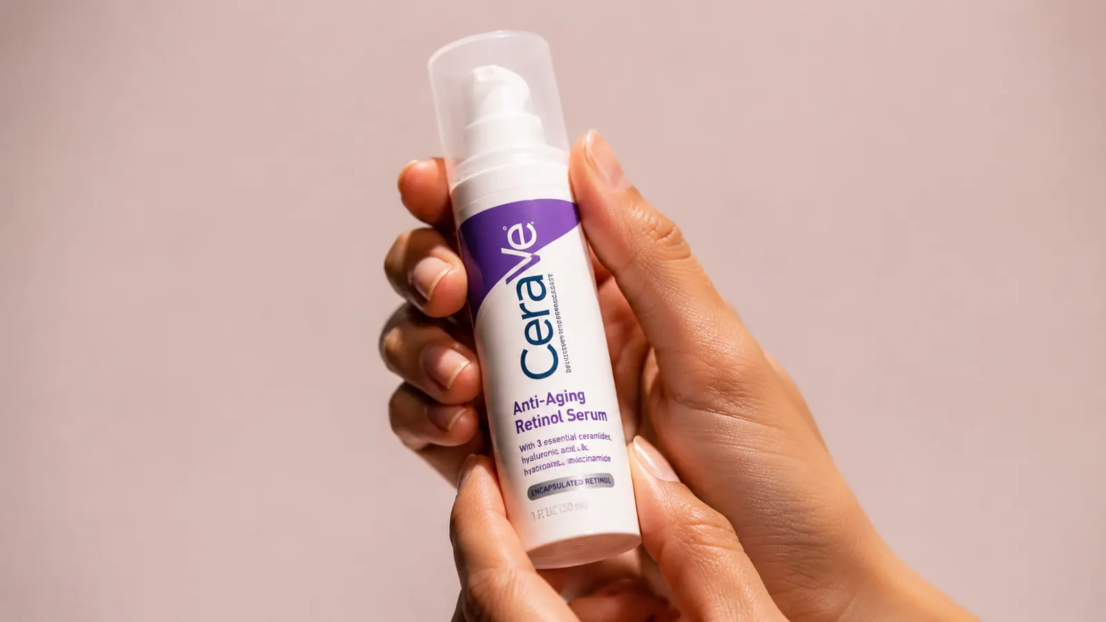 Hand holding the CeraVe Retinol Serum bottle, tilting it slightly to show the label
