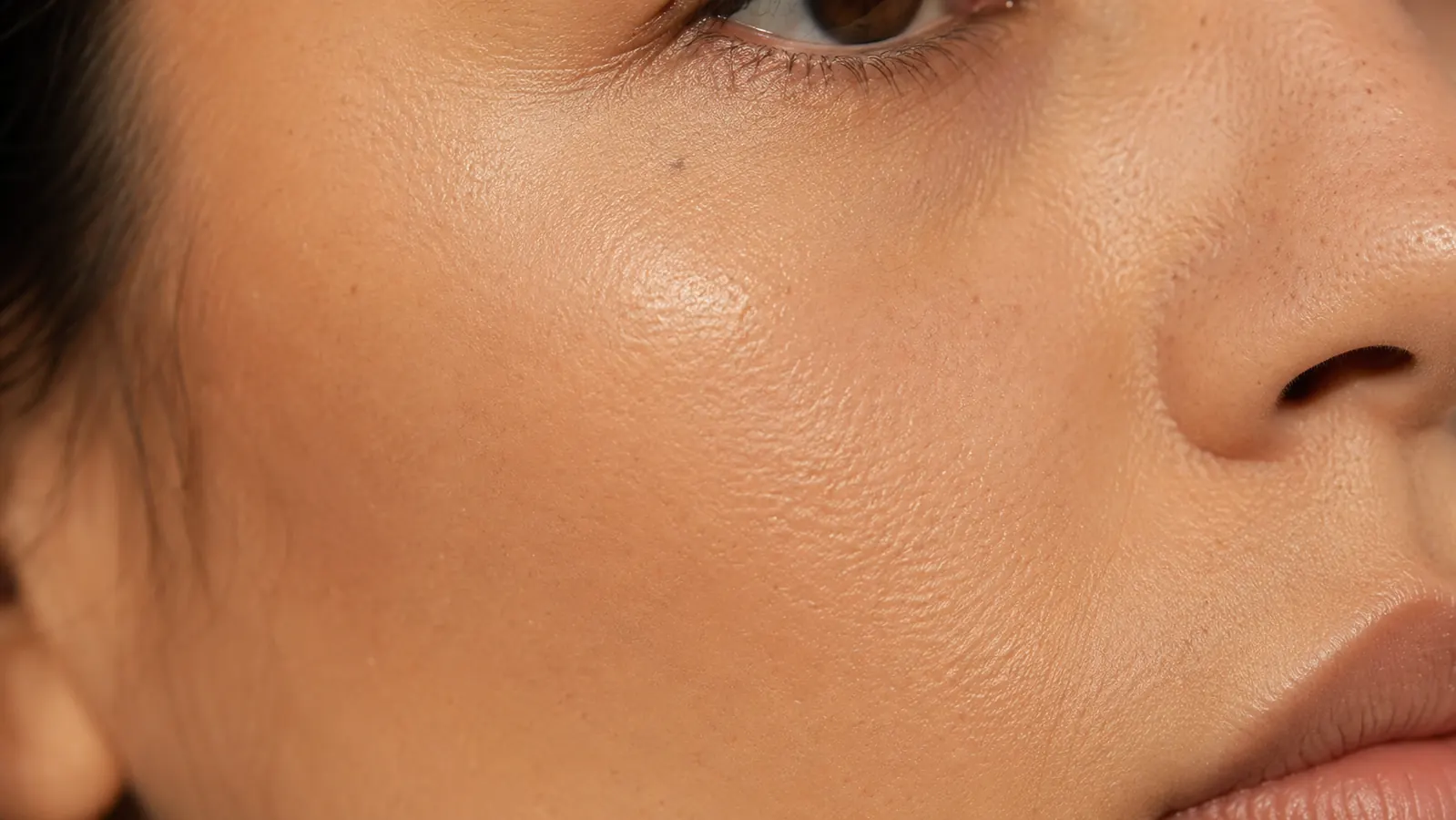 Close-up of skin showing even, natural-looking finish with no white cast after applying tinted mineral sunscreen
