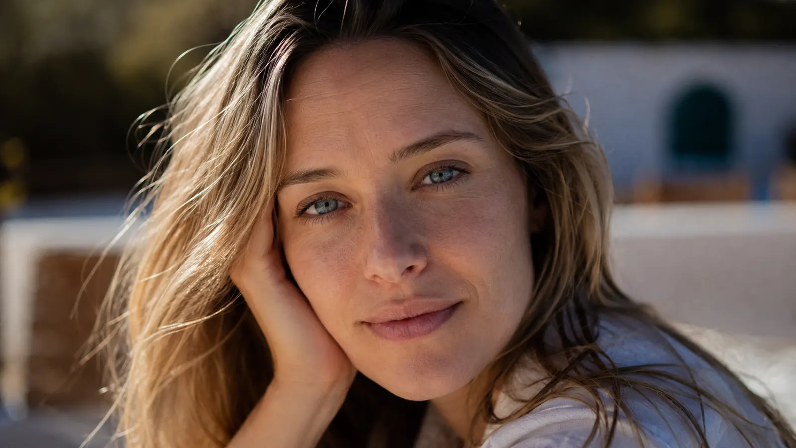 Person outdoors in daylight with visibly smooth, even-toned skin and no white cast